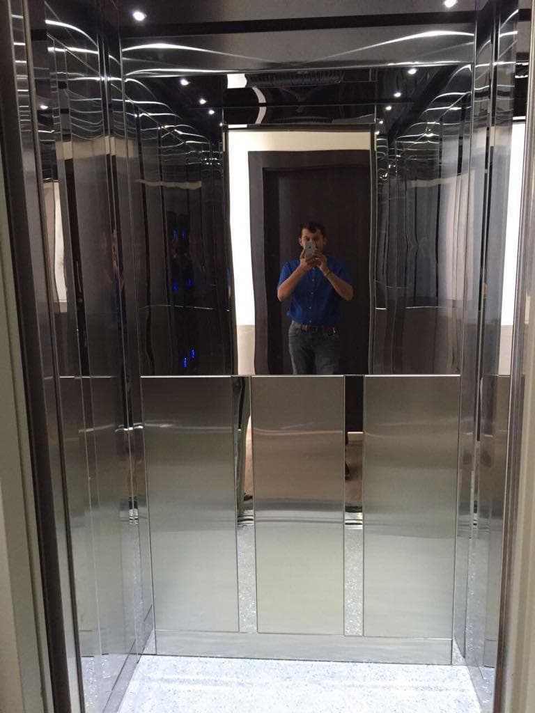 Contemporary mirror-finish elevator cabin interior